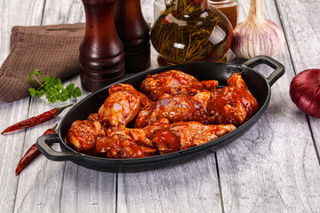 Raw marinated buffalo chicken wings