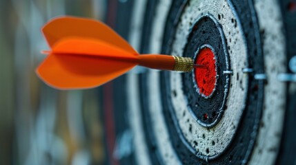 An orange dart is embedded in the center of a bullseye target, showcasing precision in darts.
