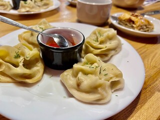 uzbek cuisine manti with sauce close-up in a restaurant dinner for two authentic