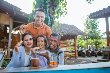 potrait of asian having family lunch in outdoor cafe