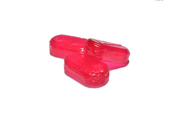 Raspberry flavored lollipops lie on a white background.