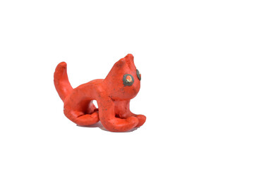 Toy made of plasticine cat. Side view. Isolated on white background.