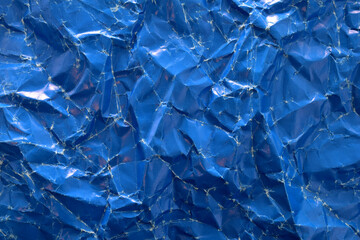 Background and texture of crumpled blue paper sheet.