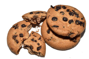 Broken and whole oatmeal chocolate chip cookies lying on white.