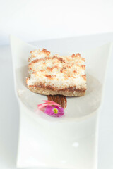 plate of coconut cake dessert with flower decoration
