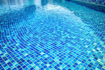 Swimming pool water surface and ripple wave with blue mosaic tiles