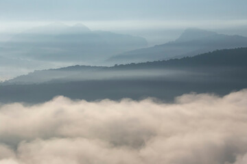 The weather is hot and humid, with a lot of water vapor creating a sea of mist in the foreground in the valley