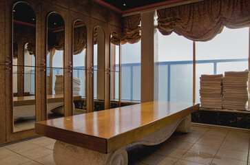 Male locker changing room with lockers, towel rack, sink and amenities inside spa thermal suite...