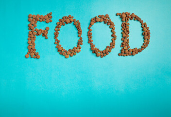 Background with the word Food, text built from dry pet food. Graphic resources for pet shop promotion.