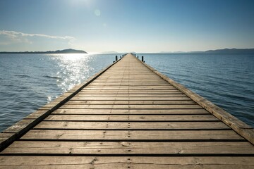 Fototapeta premium Wooden pier stretching into the distance with sunlight reflecting off its surface, pier, water