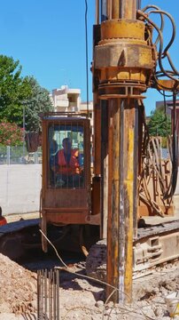 Hydraulic drilling rig for Installing a bored piles with a casing string on a construction site. Construction of drilled piles for a buried tunnel bulkhead