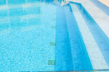 Obraz premium Empty swimming pool with sunbed and white umbrella in resort hotel for vacation leisure and white sand,resort neary sea and beach in summer..