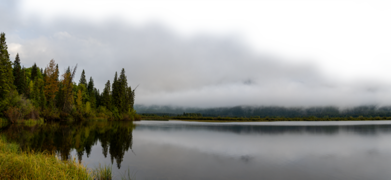 Early misty morning at autumn colored lake with cloudy sky fading to transparent. Vermillion Lake Banff
