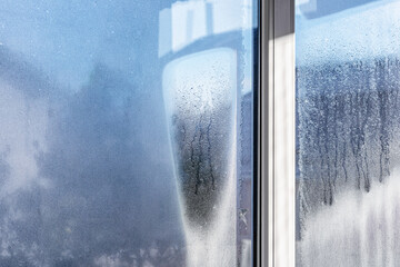 Drops of condensation on the metal-plastic window. Fragment of a plastic window with water...