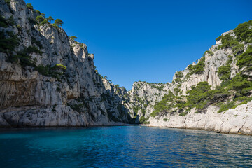 A bay in the parc of the calanques near Marseille and Cassis with light blue water on a sunny day.