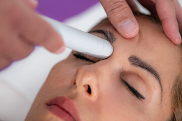 Fototapeta premium Physical therapist uses a laser device to treat a patients sinus area, targeting sinus pain and inflammation for relief and promoting faster healing and recovery.
