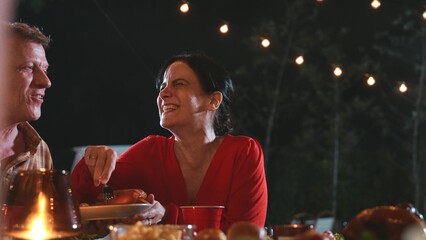 Generous grandmother together with family celebrate holiday in garden eat dinner food. Outdoor camping activity, relax with relative and spend time for tasty meal strengthen family bond. Divergence.