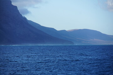View on Famara cliffs from the ferry, La Graciosa, canary islands, lanzarote, volcanic rocks, november 2024, holiday, nature, mountain, volcanic island, wild birds