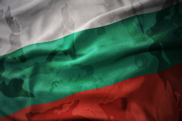 colourful waving flag of bulgaria on the old army khaki texture background. military concept.