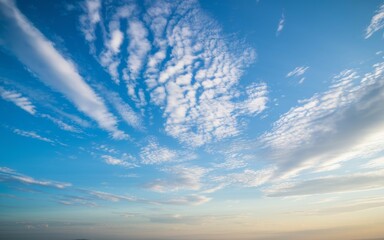 Obraz premium Blue sky white cloudscape. Serene landscape; airy, bright clouds drift across a vivid blue sky. Peaceful atmosphere.