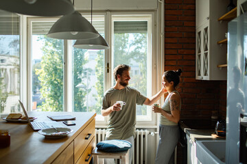 Young couple sharing a tender moment in the kitchen