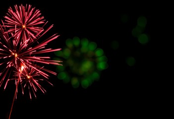 Fototapeta premium Vibrant fireworks exploding in the night sky.