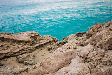 a rocky coast with azure water aya napa, cyprus
