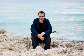 a young man on rocky coast with turquoise water of Ayia Napa, Cyprus