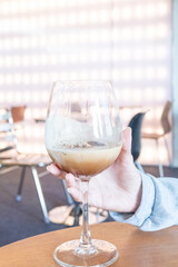 Young girl holding glass of Cold Mocktail on table,female hand swirling red wine in wine glass,Friends cheering with wineglasses.