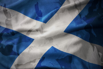 colourful waving flag of scotland on the old army khaki texture background. military concept.