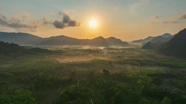 Hyperlapse aerial drone view of sunrise over forest with morning fog, P