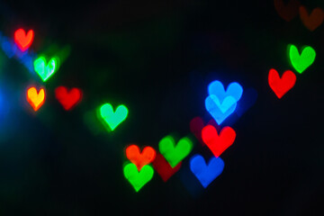 a blurry image of hearts with the words love in the middle.