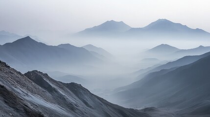 A mountain range shrouded in smog, where the peaks are barely visible, and the surrounding valleys are filled with gray haze. 