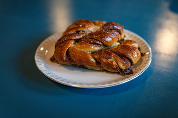 Delicious Cinnamon Pastry on White Plate With Cozy Lighting