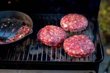 grilling hamburgers on barbecue grill,