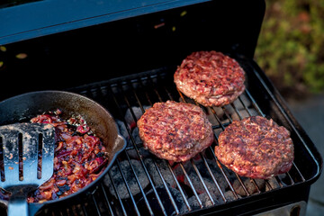 grilling hamburgers on barbecue grill,