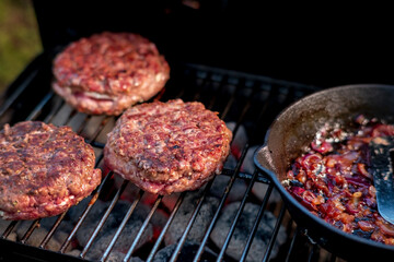 grilling hamburgers on barbecue grill,