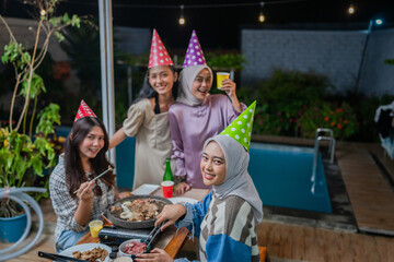 Friends enjoy a lively outdoor party with delicious food, laughter, and good vibes