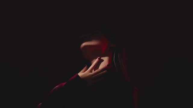 Portrait of attractive girl in a red leather jacket with healthy clean skin and beautiful make-up. Aesthetic cosmetology and makeup concept.