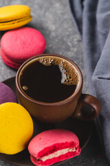 A cup of espresso coffee with macaroni cookies