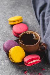 A cup of espresso coffee with macaroni cookies