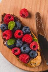 Sandwiches with chocolate paste, raspberries and blueberries