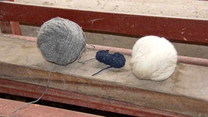 Balls of hand spun yarn dyed with natural dyes in a weaver's worshop in Carabuela, Ecuador