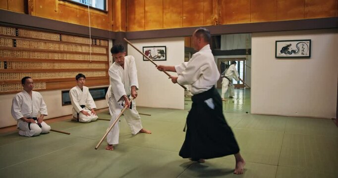 Master, student and teaching for fight, aikido and martial arts with fitness, kung fu and stick in Japan. Training, bokken and sensei for karate, battle and self defense class with exercise in dojo