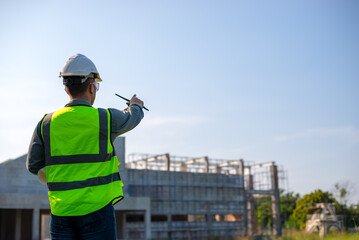 Engineers use walkie-talkies to communicate in building construction.