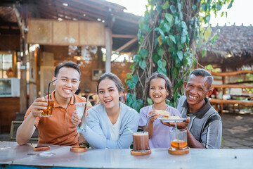 potrait of asian family having lunch together in outdoor cafe