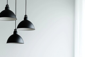 Modern minimalist black hanging lamps in the interior of a home or office, close-up. Copy space, free space for text