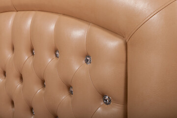 Soft headboard made of genuine leather with buttons. Upholstery of the headboard in the Capitonne way.

