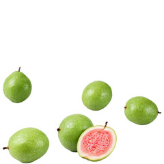 Fresh green guavas with one cut open, revealing its juicy pink interior.