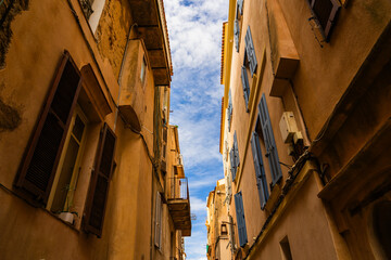 Exploring narrow streets with charming architecture and vibrant skies in a historic town during the day